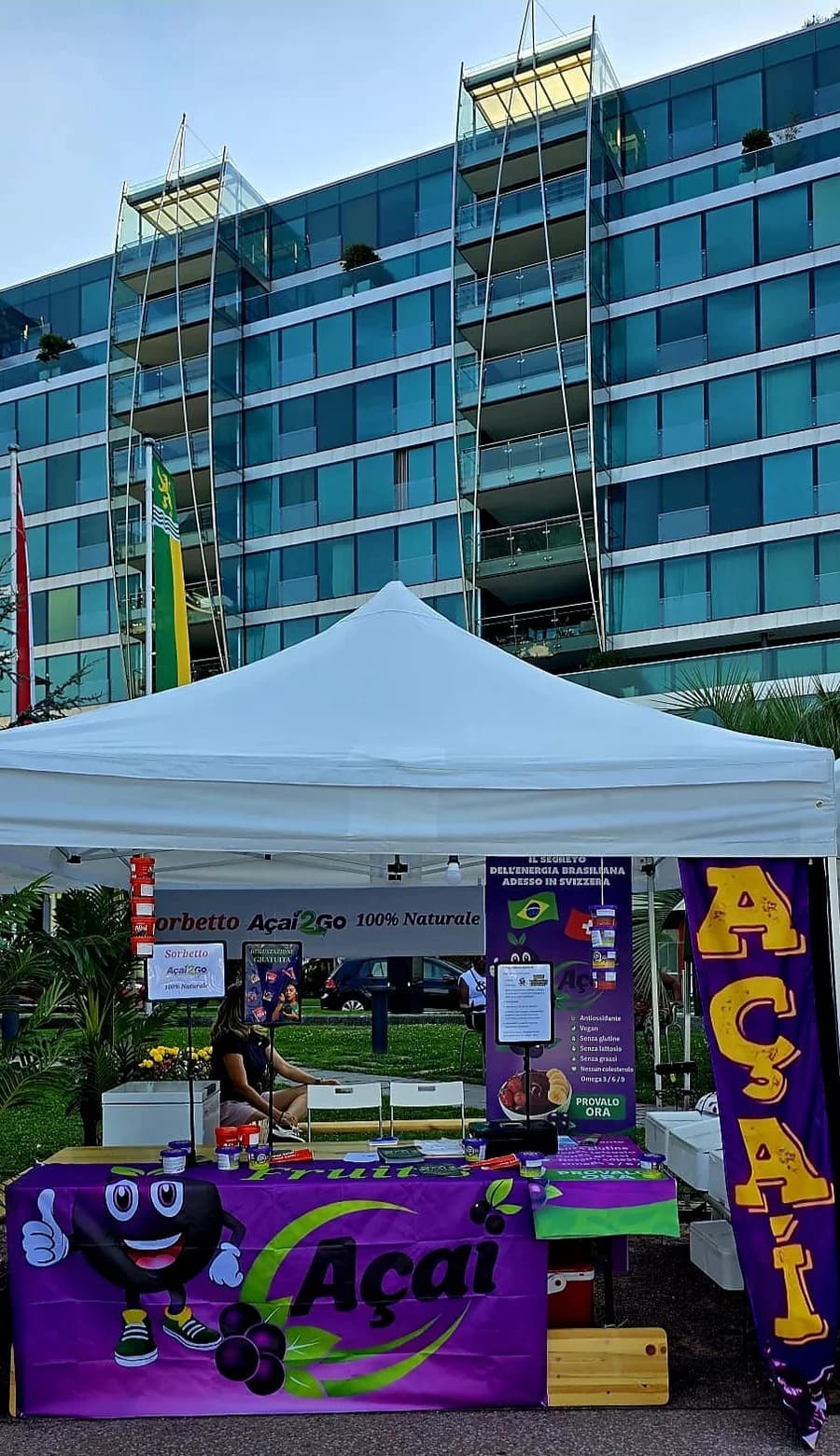 Il banchetto Fruit's Açaí a un mercato in Ticino, con gazebo e bandiera açaí